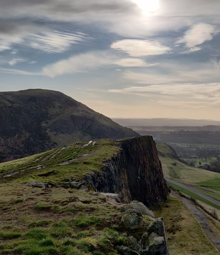 View of Alpine ridgeway with sun breaking through clouds